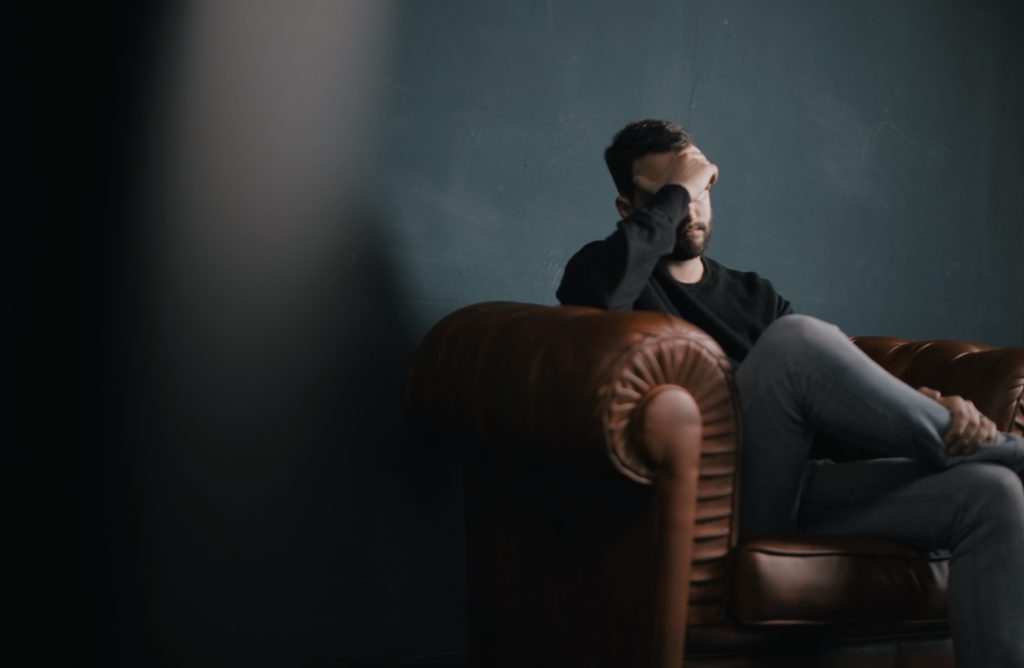 Depressed Man Sitting on The Couch
