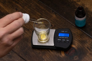 weighing cannabis tincture on digital scale